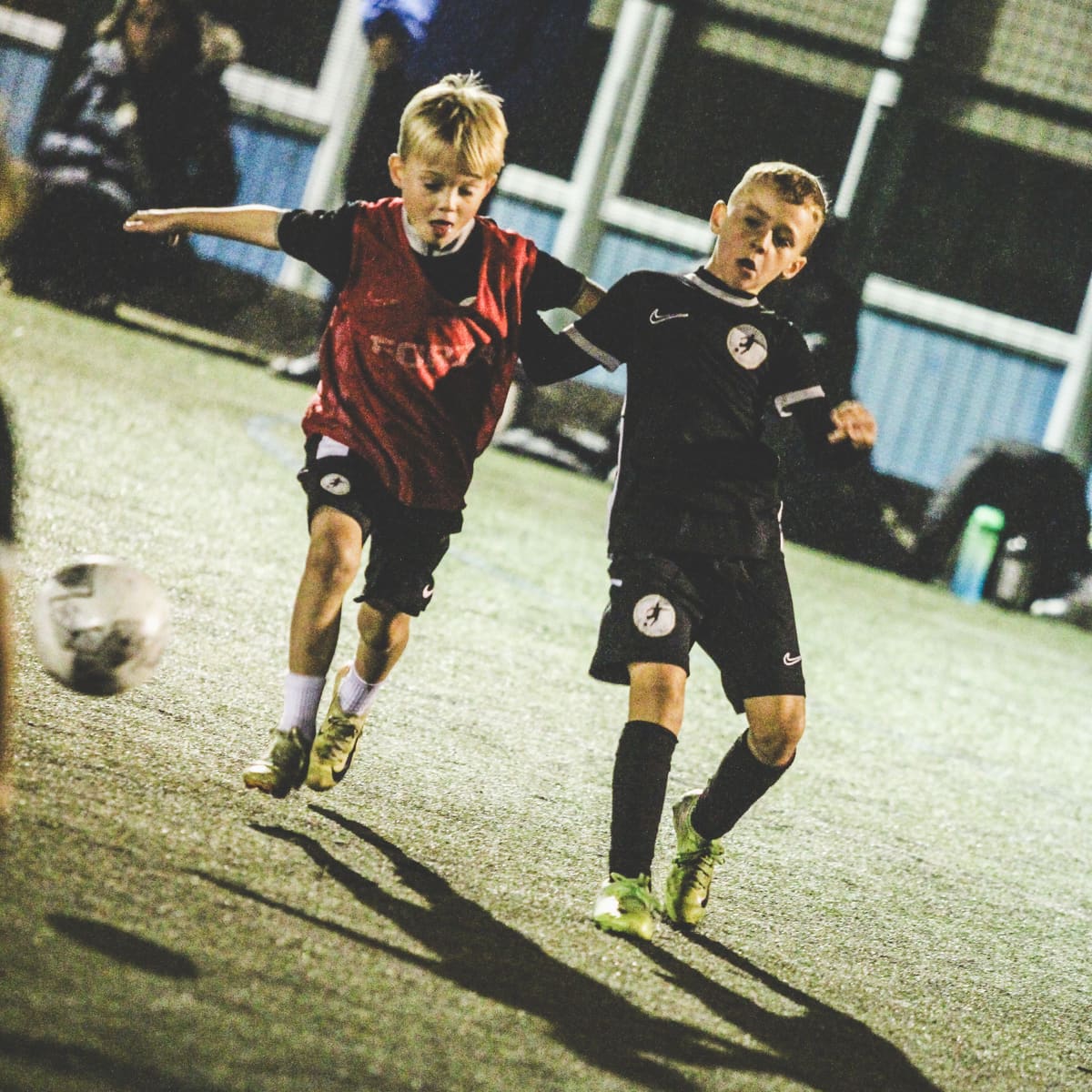 Players competing for the ball during a session